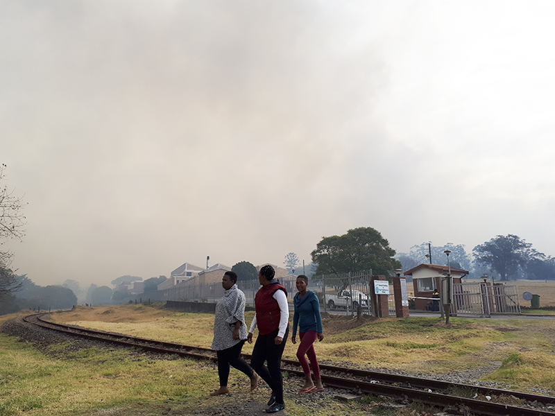 A group leaves Settlers Hospital as the fire approaches.