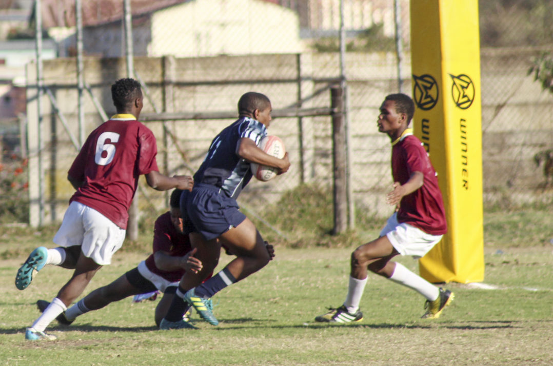 Lily White player neatly tackled low by Wanderers  player