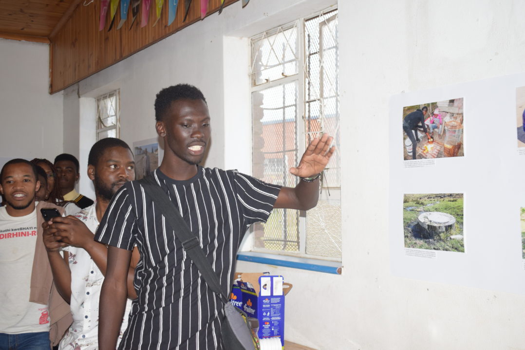 Vusumuzi Tshekema showing off his photos at the Masazaneni Exhibition at the Joza Youth Hub last Friday. Photo by: Michelle Banda